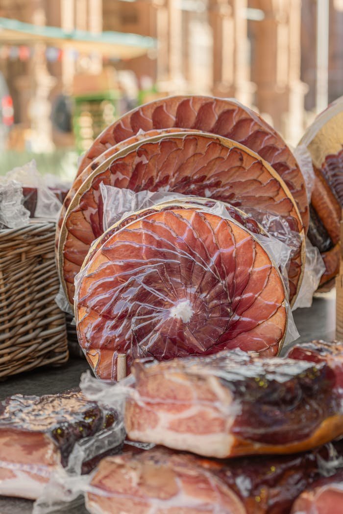 High-quality Black Forest Ham neatly sliced and displayed at an outdoor market in Germany.